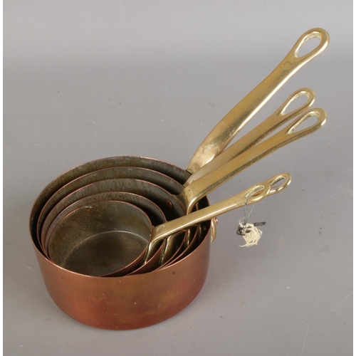 395 - A collection of antique copper pans, in various sizes, some bearing marks such as 