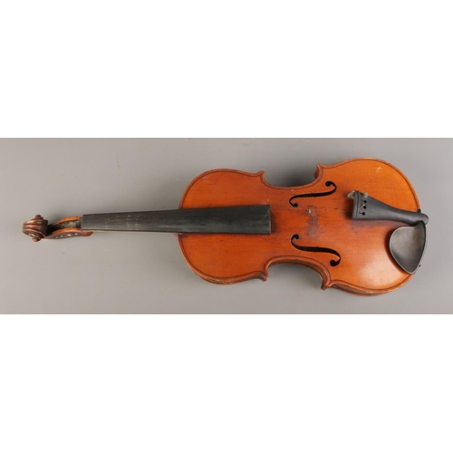 56 - An early Twentieth century cased violin with two piece back, for restoration. Label inside for Wolff... 