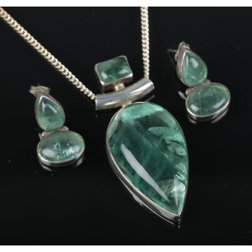 523 - A silver and green coloured quartz pendant on silver chain with a pair of matching earrings.