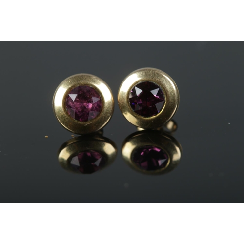 533 - A pair of 9ct gold amethyst paste earring studs.

0.7g