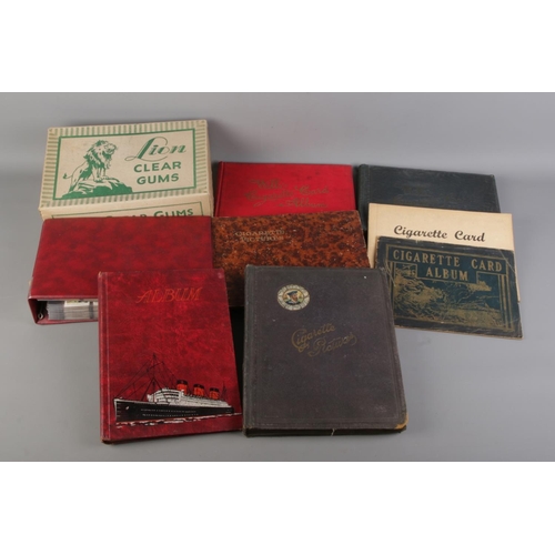 66 - A large quantity of cigarette cards with albums, including two complete albums, six empty albums and... 