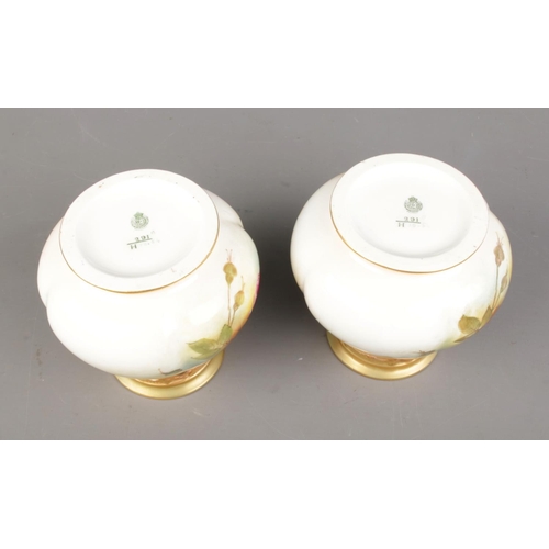 612 - A pair of small Edwardian Royal Worcester vases by FJ Bray. The lobed bulbous bodies are painted wit... 