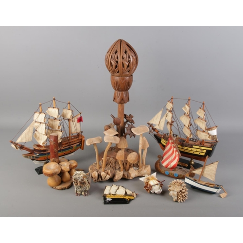 75 - A collection of wooden items. Includes carved hardwood opening lotus, model boats, mushroom displays... 