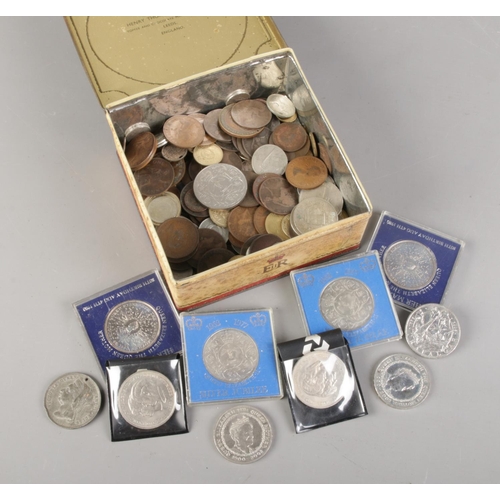 77 - A tin of coins. Includes commemorative five pounds, pre decimal, Queen Victoria medallion etc.