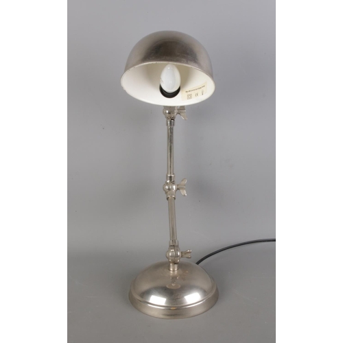 82 - A vintage table lamp in chrome, with dual articulated.