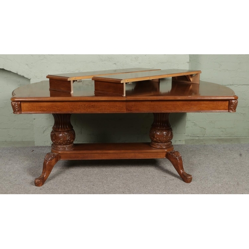 630 - A large carved Chinese hardwood extending dining table, with two additional leaves; 'Ancillary Herit... 