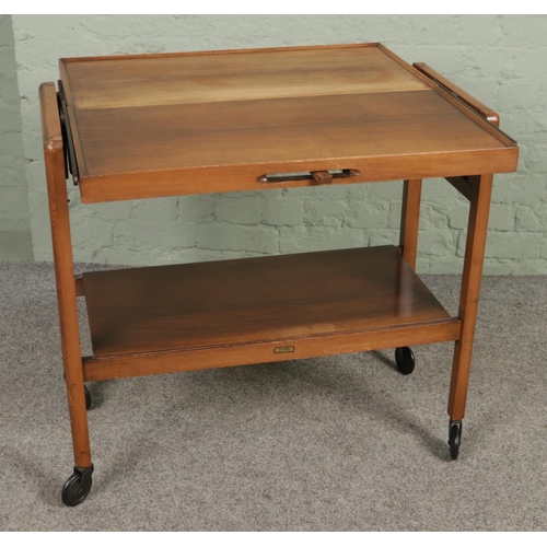 638 - A mid-century 'Tri-Magic' metamorphic drinks trolley and table, on casters.