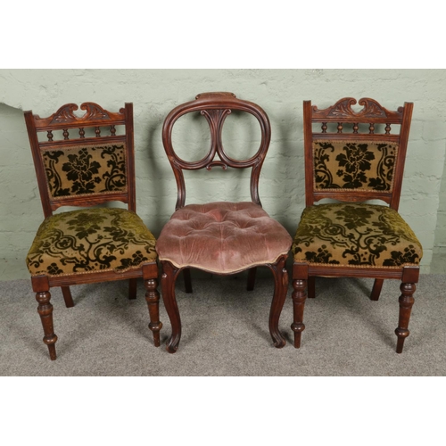 540 - A pair of Victorian mahogany salon chairs along with a balloon back example.