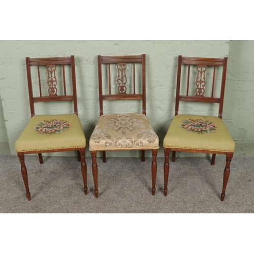 547 - Three Edwardian carved and over-stuffed salon chairs. Height 86cm, width 44cm.