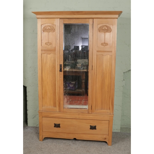 542 - A carved mirror front wardrobe over single drawer featuring floral motif to side panels. Approx. dim... 