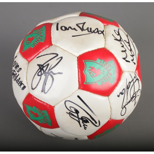 14 - A signed Liverpool FC 100 years centenary football featuring players such as Ian Rush, Bruce Grobbel... 