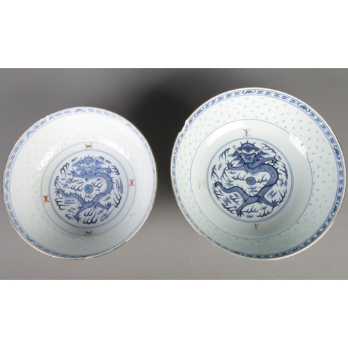 17 - Two Chinese blue and white rice grain pattern bowls both featuring central dragon motif in underglaz... 