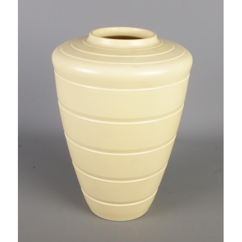 2 - A Wedgwood Keith Murray straw glazed vase, designed circa 1934, featuring a shouldered form with ste... 