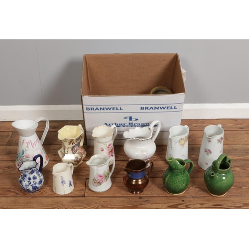 222 - A large box containing an assortment of water jugs, primarily ceramic in various sizes.