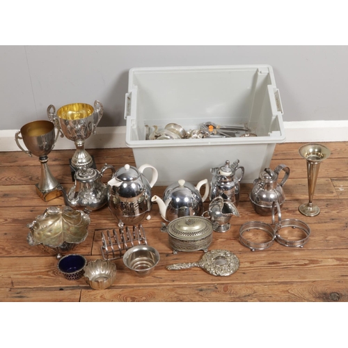 225 - A box containing silver plated and white metal items, featuring teapots, trophies, jugs and various ... 