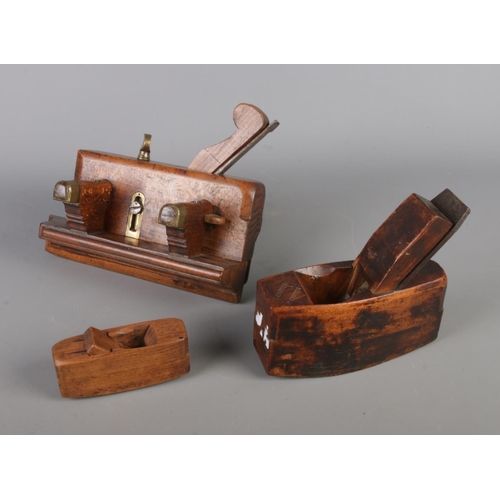 34 - Three 19th century antique woodworking tools, including tool with turned clamp handles and planes.