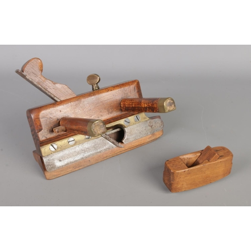 34 - Three 19th century antique woodworking tools, including tool with turned clamp handles and planes.