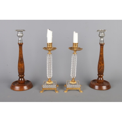 36 - Two sets of vintage candlestick holders, comprising a gilt and cut glass pair raised on lion paw fee... 