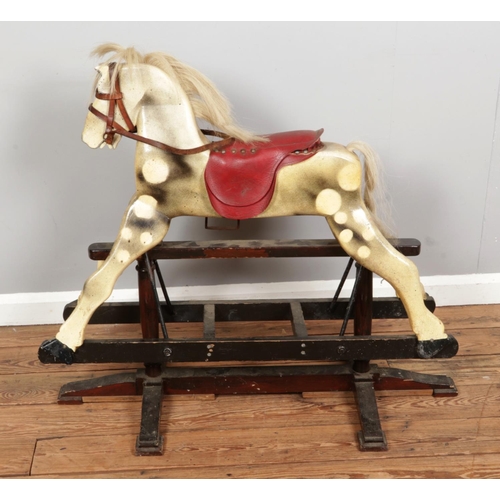 303 - An antique wooden rocking horse, made from solid wood with original paint and hair, measuring H85 x ... 