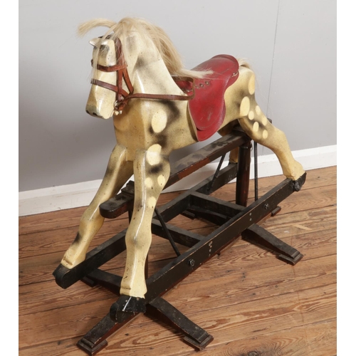 303 - An antique wooden rocking horse, made from solid wood with original paint and hair, measuring H85 x ... 