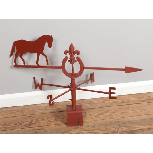 305 - A iron weather vane indicator with horse decorations, painted in red, size H30 x W62cm.