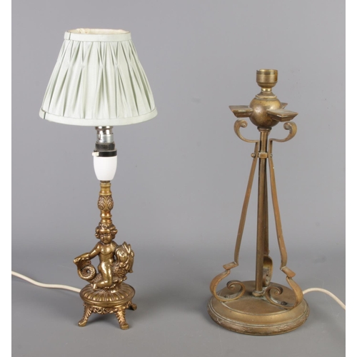 308 - Two vintage brass table lamps: one features a tripod-style with scroll arms in an Art Nouveau style,... 