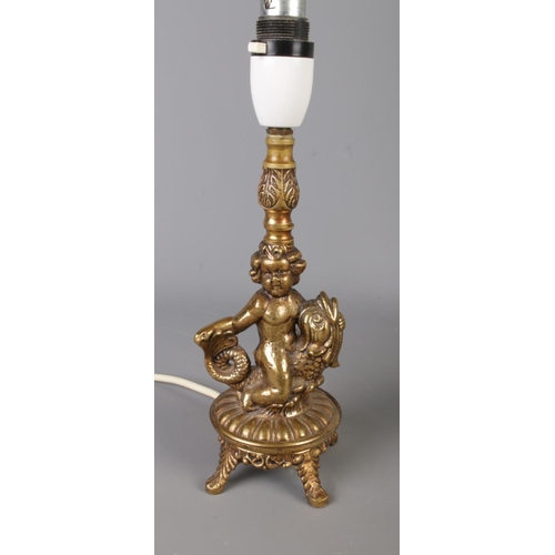 308 - Two vintage brass table lamps: one features a tripod-style with scroll arms in an Art Nouveau style,... 