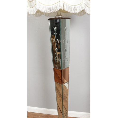 311 - A mirrored glass body floor lamp, with bevelled edges, etched floral patterns and wooden square base... 