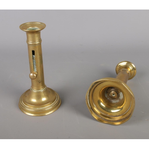 48 - A pair of 19th century brass candlesticks, featuring integral sliding height adjuster on round turne... 