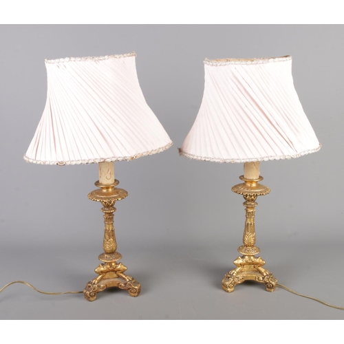 50 - A pair of vintage decorative table lamps, with gilt on wooden bodies, clawed feet and egg-shaped sha... 