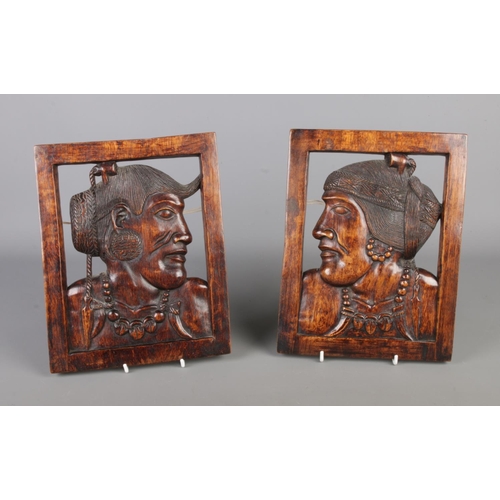 357 - A pair of traditional Philippine hand-carved solid wooden hanging wall plaques depicting Igorot peop... 