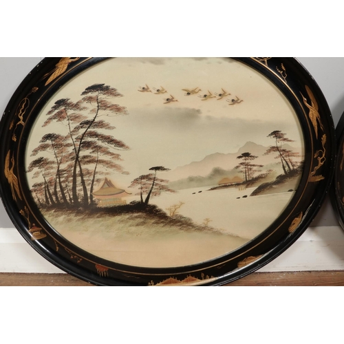 376 - A pair of early 20th century watercolours, river scenes, in Japanned oval frames. 39cm x 48cm.