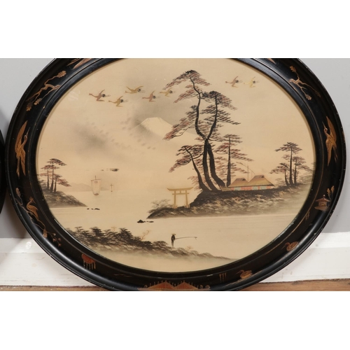 376 - A pair of early 20th century watercolours, river scenes, in Japanned oval frames. 39cm x 48cm.