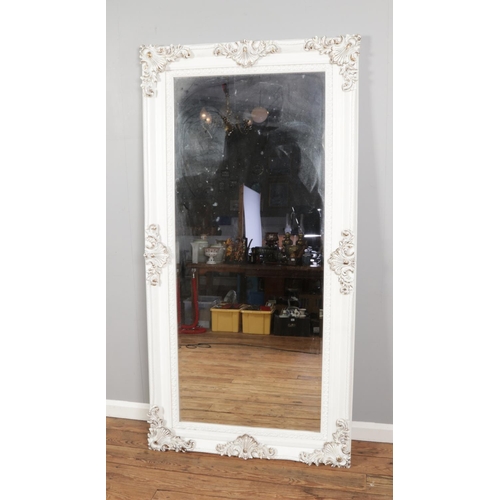 382 - A large white painted and gilt bevel edge wall mirror with carved shell detail. Approx. dimensions o... 