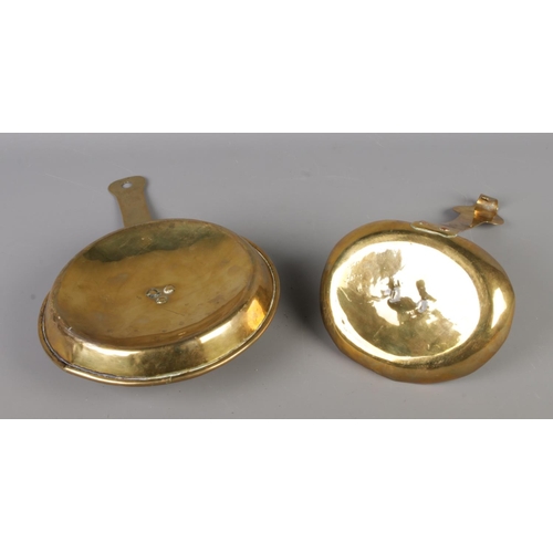 56 - Two 18th century brass chamber-sticks, one example with hook ended suspension handle and other rivet... 