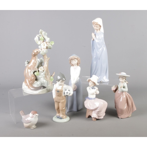 57 - A collection of Lladro and Nao figures. Includes Lladro Ermine example.