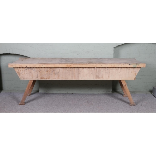 351 - A very large pine and ply workbench. Height: 85cm, Width: 252cm, Depth: 70cm.