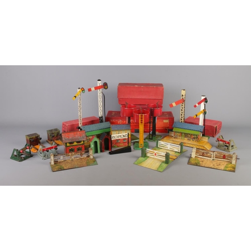 220 - A box of 'O Gauge' buildings, accessories and features, mainly by Hornby. Together with a case of sp... 