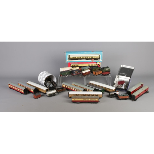 232 - A box of 'OO' gauge railway wagons, coaches and tender. To include examples from Hornby Dublo, Klein... 