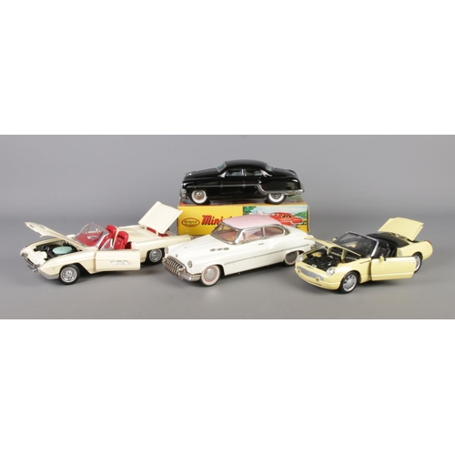 298 - Four large scale model vehicles, to include Anson and Maisto Ford Thunderbirds and Minister Delux fr... 