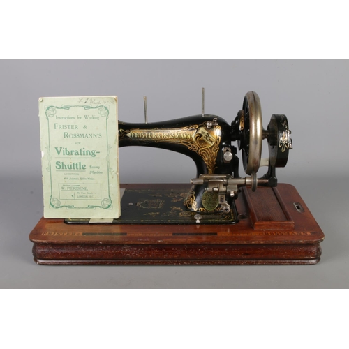 300 - An early twentieth century wooden cased Frister and Rossman's hand crank vibrating - shuttle sewing ... 