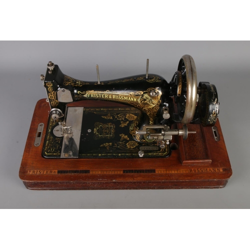 300 - An early twentieth century wooden cased Frister and Rossman's hand crank vibrating - shuttle sewing ... 