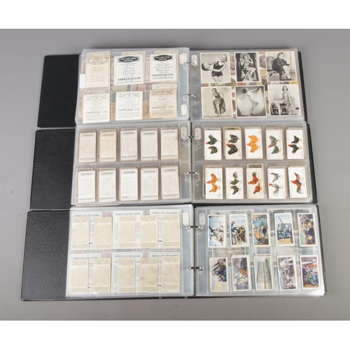 47 - Three albums of part sets of Cigarette and collectors cards, surrounding the themes of Royalty, Mili... 