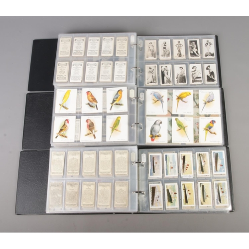 47 - Three albums of part sets of Cigarette and collectors cards, surrounding the themes of Royalty, Mili... 