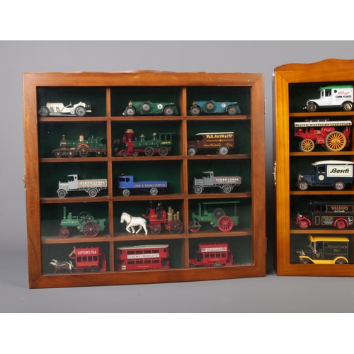 51 - Three display cabinets with glazed fronts housing model die-cast vehicles. Includes examples from Le... 