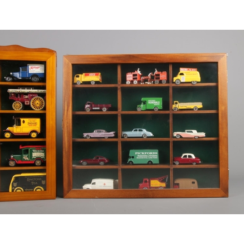 51 - Three display cabinets with glazed fronts housing model die-cast vehicles. Includes examples from Le... 