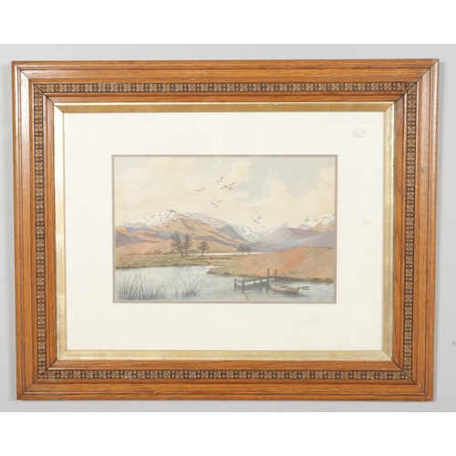 379 - C. A. Jobborn (20th Century), a framed watercolour of a mountainous scene, with lake and rowing boat... 