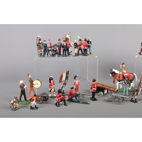 55 - A large collection of painted lead soldiers, containing several Britain examples. Includes drummers ... 