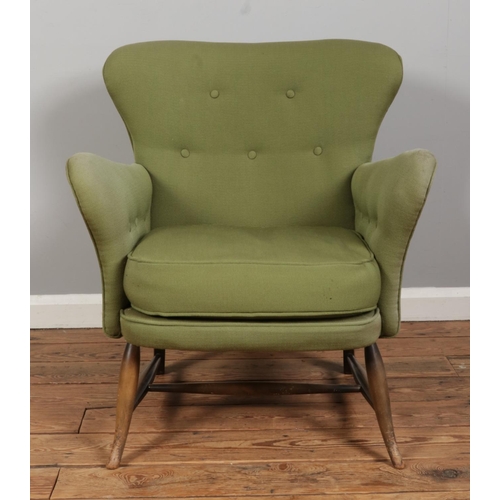 549 - An Ercol tub armchair, model 236, with button back and sides. Upholstered in olive green.