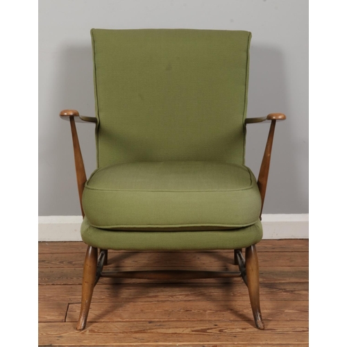 552 - A vintage Ercol armchair, Model 248, upholstered in light green fabric to the cushioned back rest an... 